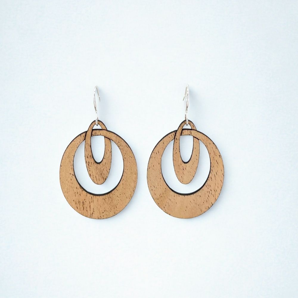Wooden hoop earrings that look like overlapping ovals on a white background