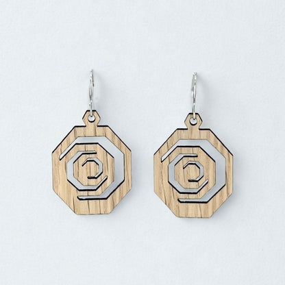 Wooden earrings with geometric octagon design on a light gray background