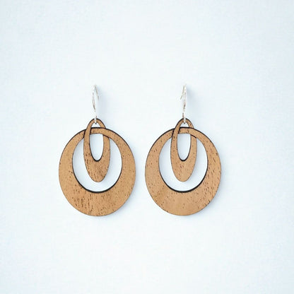 Wooden hoop earrings that look like overlapping ovals on a white background