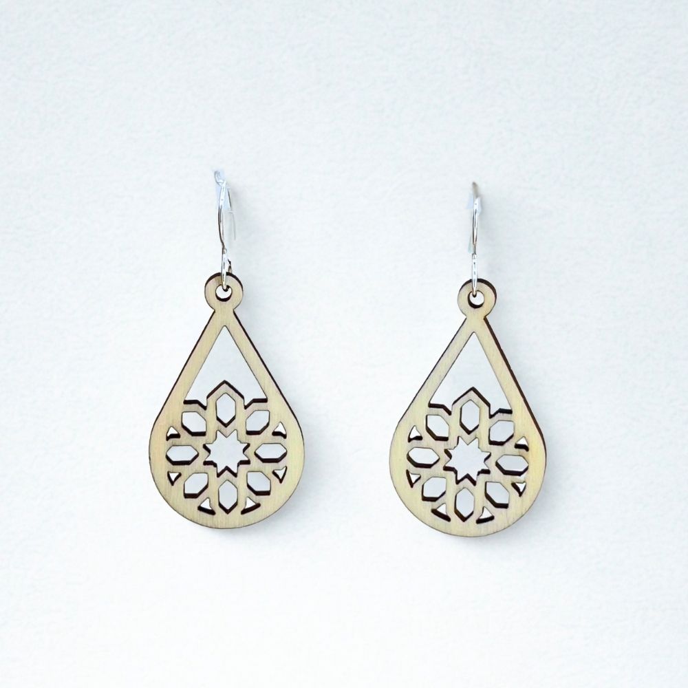 Sustainable aspen wood teardrop-shaped earrings with intricate cut-out designs and recycled sterling silver ear wires on a white background