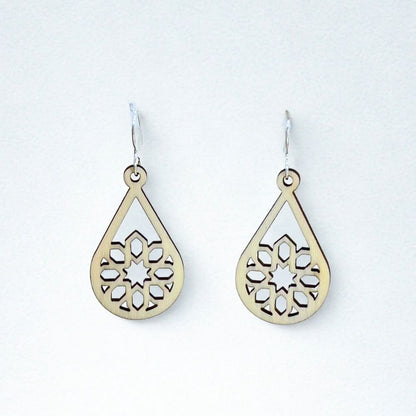 Sustainable aspen wood teardrop-shaped earrings with intricate cut-out designs and recycled sterling silver ear wires on a white background