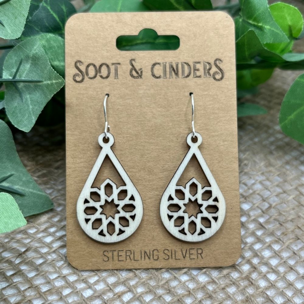 Aspen wood and recycled sterling Silver earrings on a 'Soot & Cinders' branded card with green leaves in the background