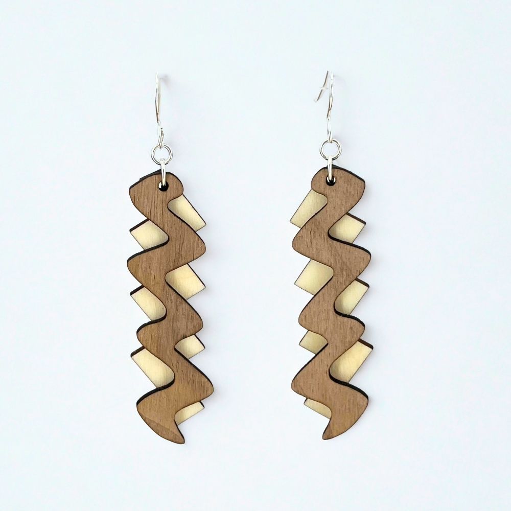 Wooden earrings with wavy design on a white background